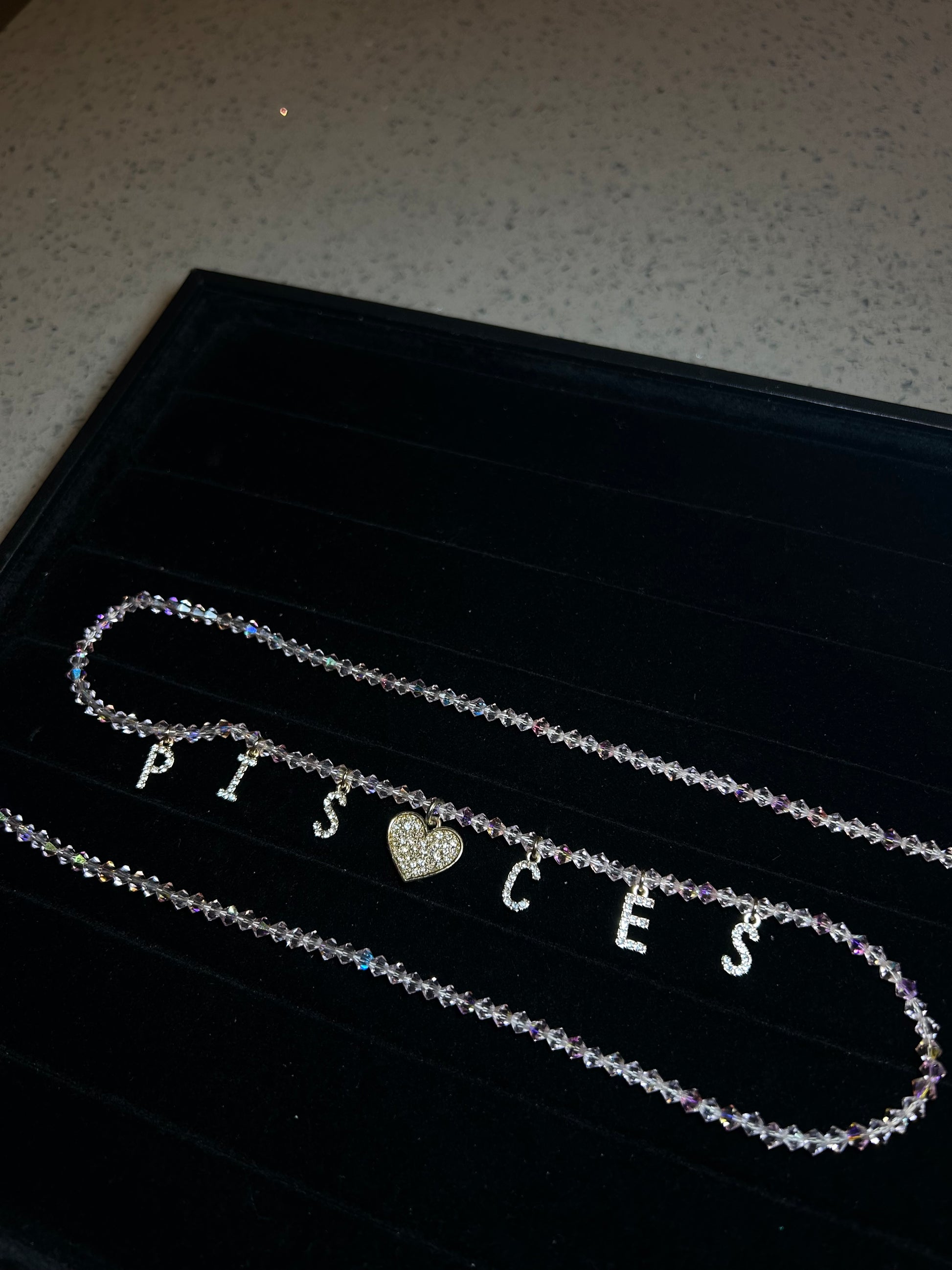 Necklace with a heart pendant on a black background