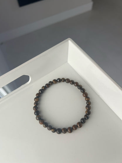 Beaded bracelet on a white surface with a blurred background. Best Crystal Bracelets for Protection