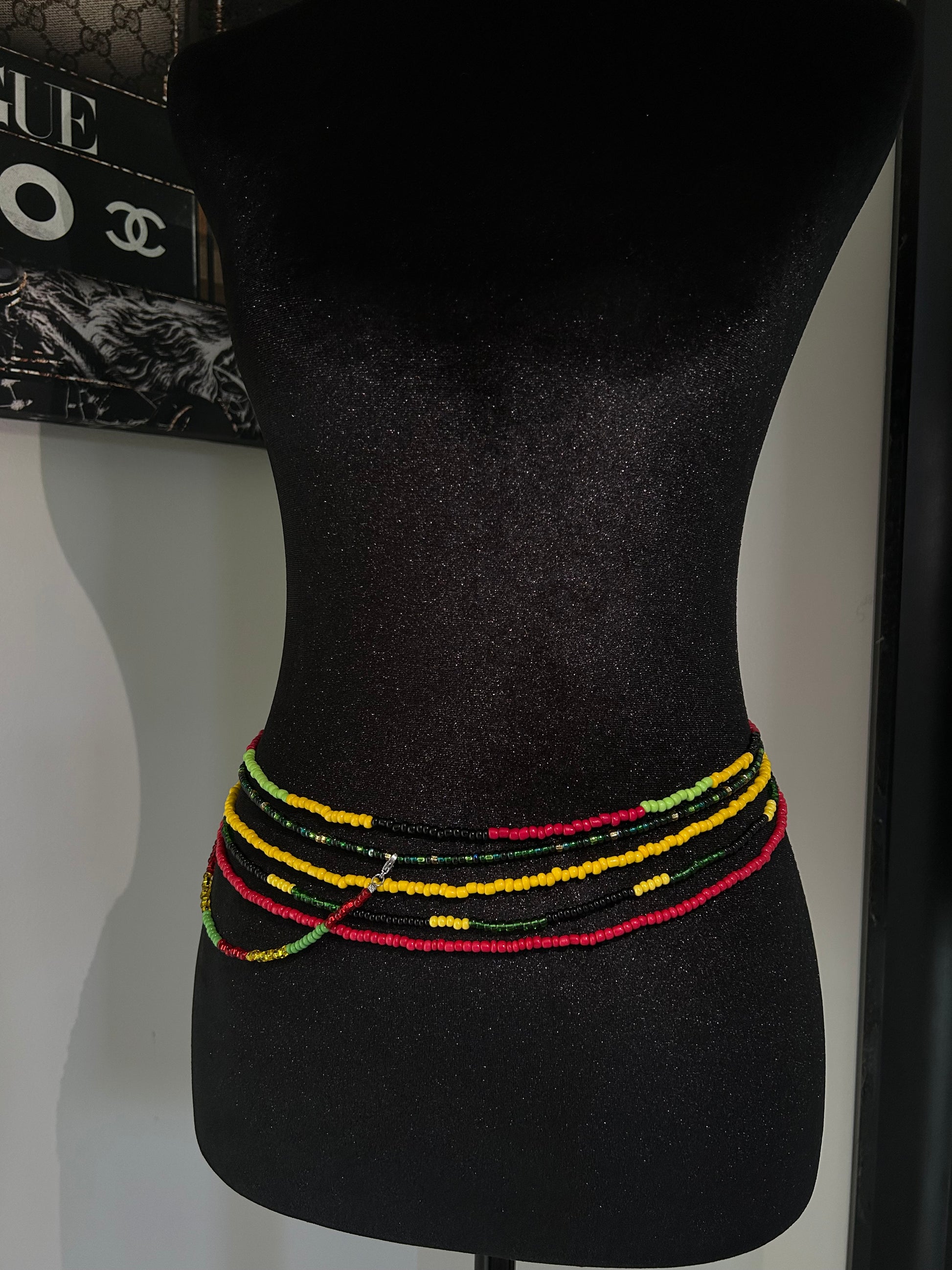 Black bow tie with colorful trim on a mannequin head, with a visible brand logo in the background.