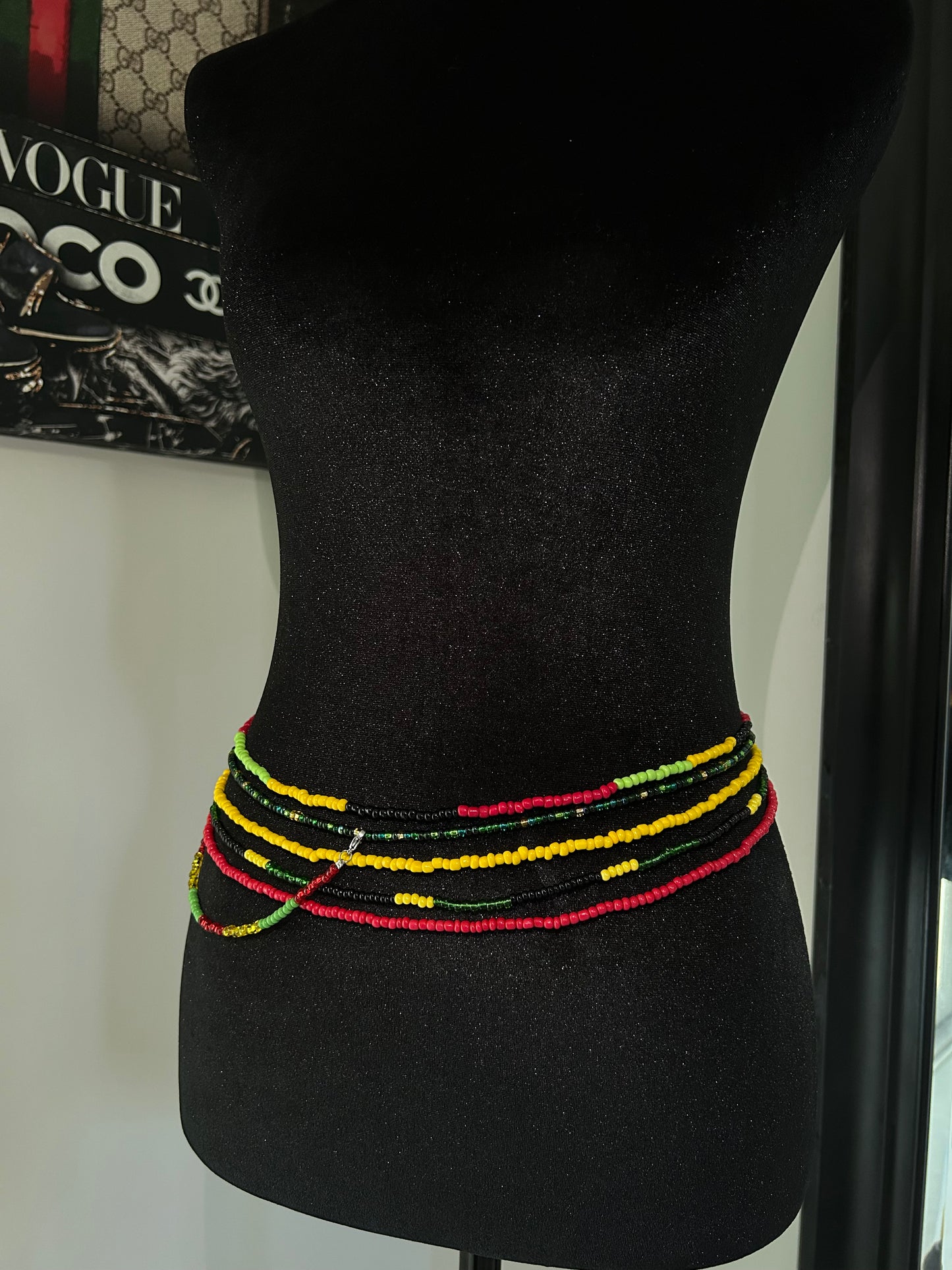 Black car headrest cover with colorful trim on a car seat.