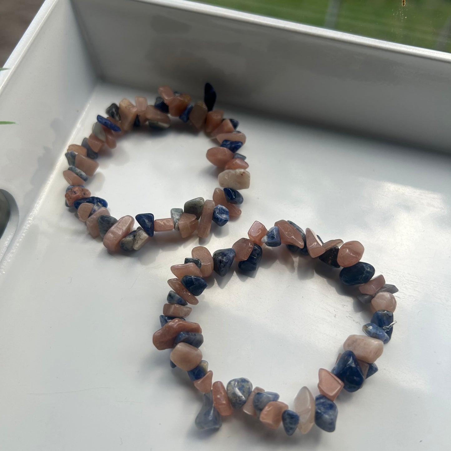 Necklace made of small stones on a white surface
