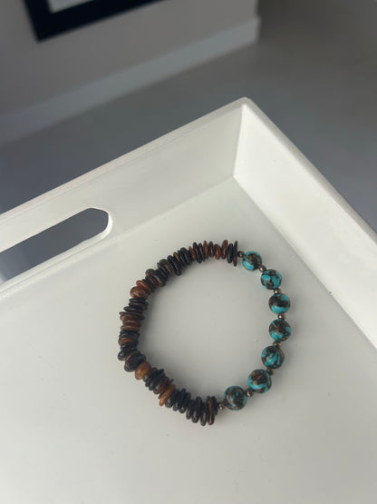 Beaded bracelet on a white surface with a blurred background