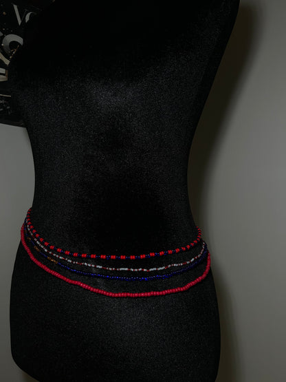 Black bow tie with red and blue stitching on a dark background