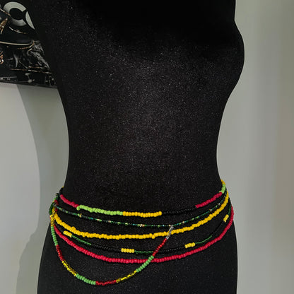 Colorful beaded bracelets on a black mannequin arm against a white background