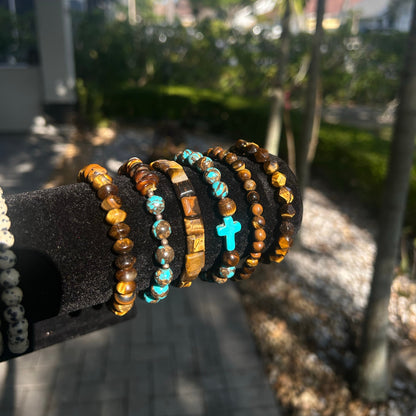 Stack of beaded bracelets on a black holder with a blurred outdoor background