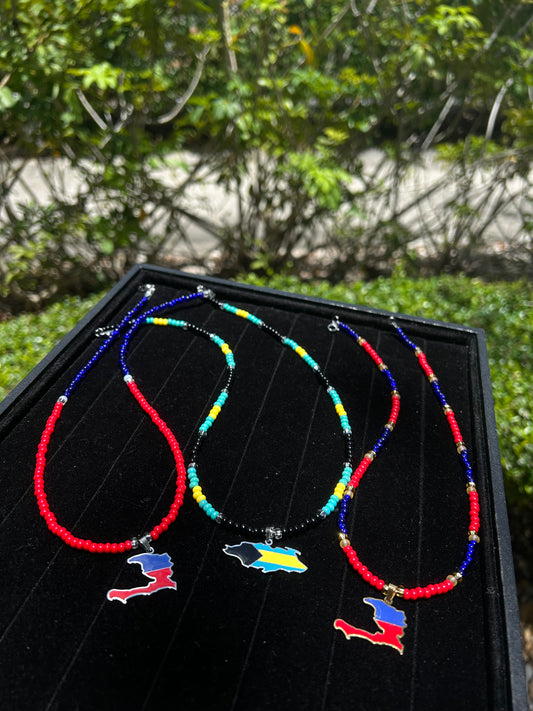Colorful beaded necklace with pendants on a black surface outdoors