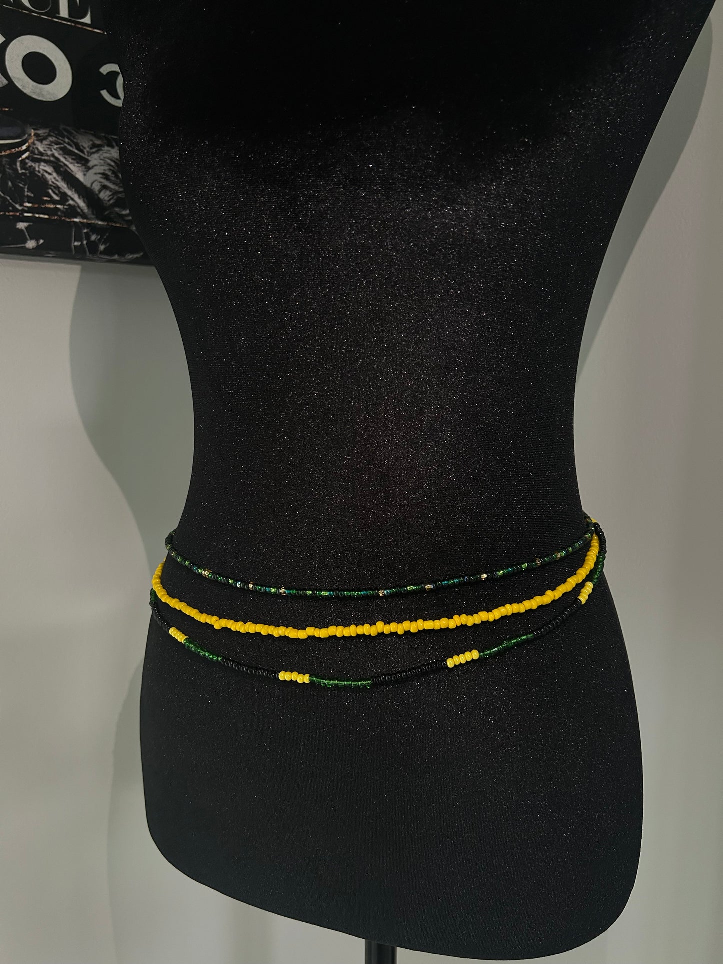 Green and yellow colored handmade Waistbead on mannequin
