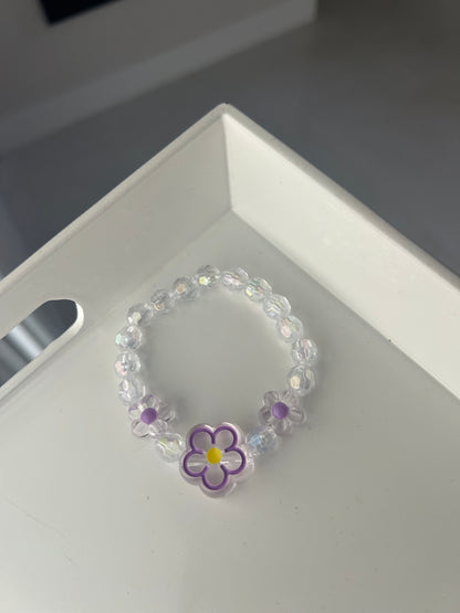 Children Crystal bracelet with a flower charm on a white surface